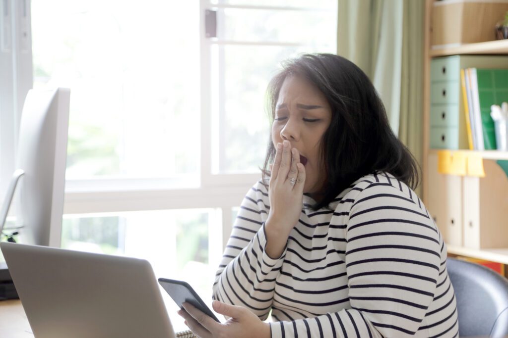 woman yawning at desk